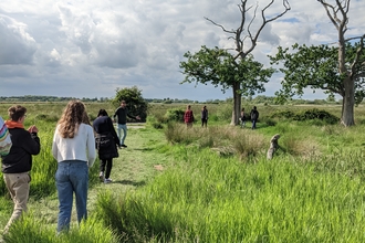 young people walking out onto the reserve at carlton marshes