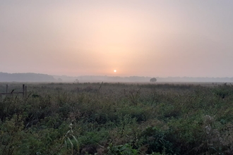 A hazy sunrise at Trimley Marshes in Suffolk