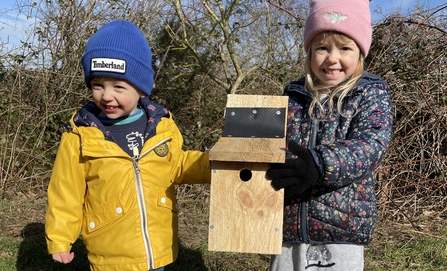 Two children with a nestbox