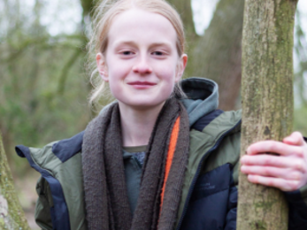 James, Youth Board member, standing by a tree, image credit Simply C Photography