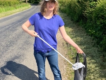 Hannah, Youth Board member, litter picking on a street