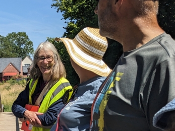 Three people having a conversation at a community event