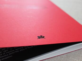 A red book on a table