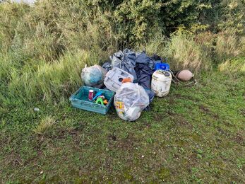 A pile of bin bags full of litter from the beach clean