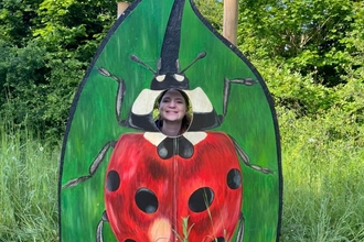 Charlotte at the Suffolk Show with a ladybird photo cut-out