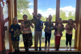 Holiday club for 6-11 year olds holding dreamcatchers they made