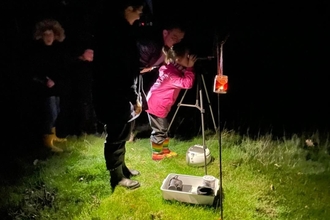 Family Night Walk a foxburrow nature reserve. Using a nightscope to spot wildlife