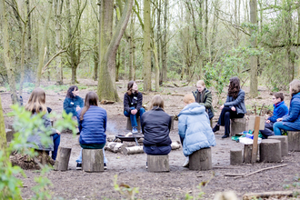 Youth Board members sitting in log circle at Foxburrow nature reserve, having a discussion