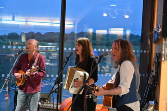 three people playing instruments 