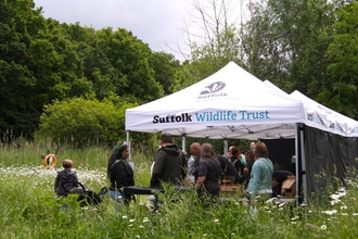 People gathered around a Suffolk Wildlife Trust gazebo at the Suffolk Show