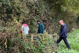 Team members crossing a footbridge