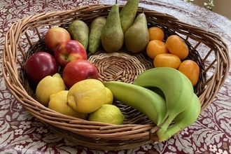 willow woven basket with fruit in on a table