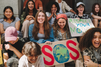A group of young people holding signs 