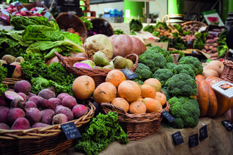 Farmers market with organic vegetables in wicker baskets