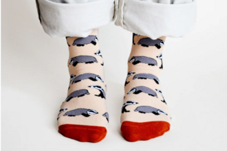 a person wearing socks with badger illustrations on them