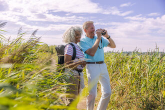 Two people looking through binoculars 