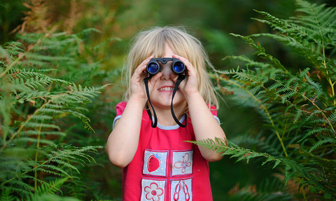 Happy girl with binoculars