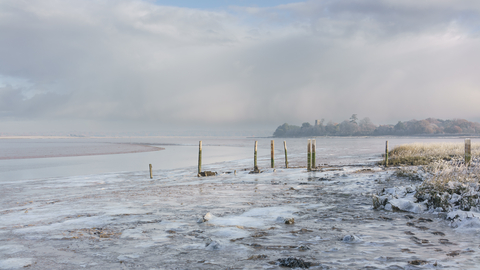 An icy view over alde mudflats towards the church 