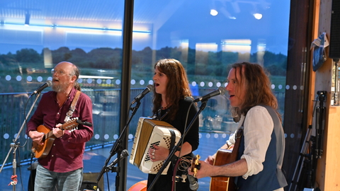 three people playing instruments 