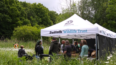 People gathered around a Suffolk Wildlife Trust gazebo at the Suffolk Show