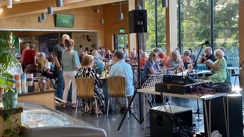 A busy visitor centre at Carlton Marshes as people eat and drink ahead of a folk concert