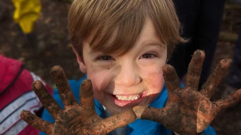 boy with muddy hands