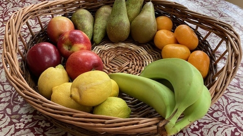 willow woven basket with fruit in on a table