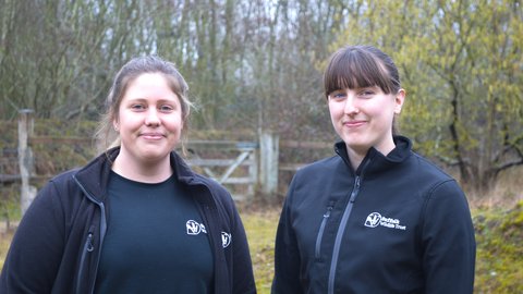 Becky and Linsey standing outside looking at the camera smiling