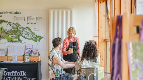 People enjoying drinks in a bright cafe 