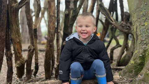 Wild Tot sitting in a den