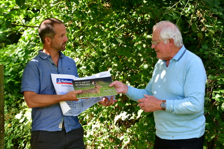 Michael Strand receiving a cheque from sales of the book by Terry Reeve