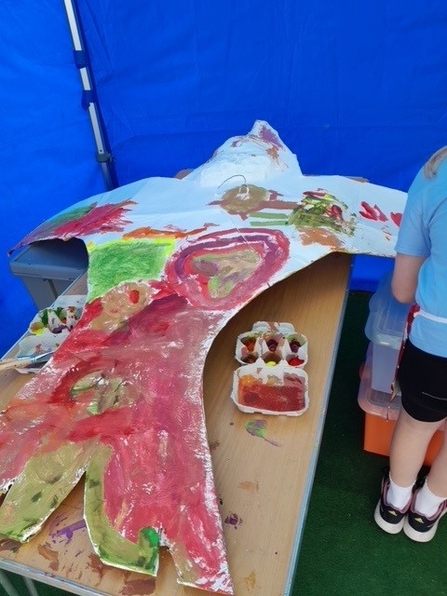 Papier-mâché bird at First Light Festival being painted by children. 