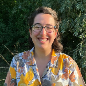 Irene, Youth Board member standing in front of a green hedge, image credit Katharine Townshend