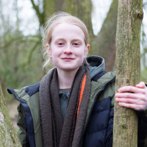 James, Youth Board member, standing by a tree