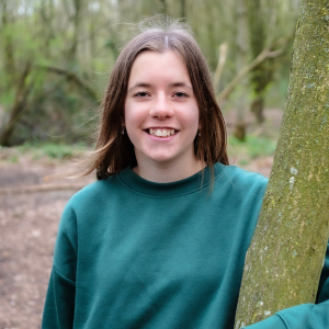 Lydia, Youth Board member, standing by a tree, image credit Simply C Photography