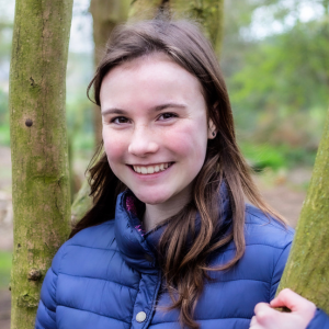 Amy, Youth Board member, standing by a tree, image credit Simply C Photography