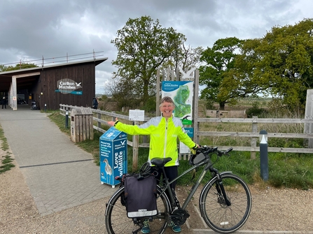 Amanda standing outside the Carlton Marshes visitor centre with her bike