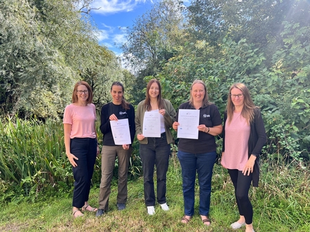 Wilder Ecology team members holding certificates 