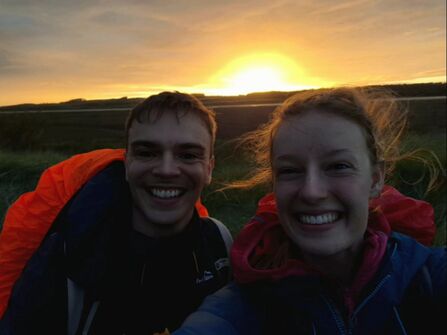 Lucy and Rupert on a walk with the sunset in the background.