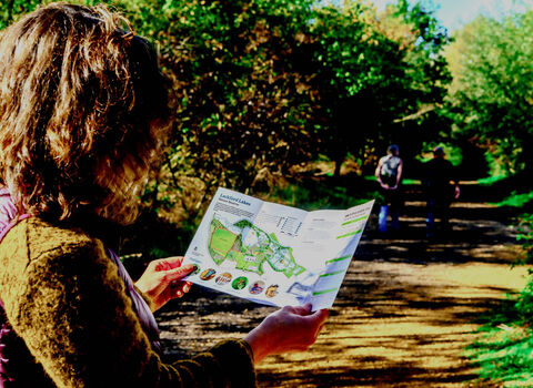 Walker holding a map of Lackford Lakes