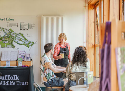 People enjoying drinks in a bright cafe 